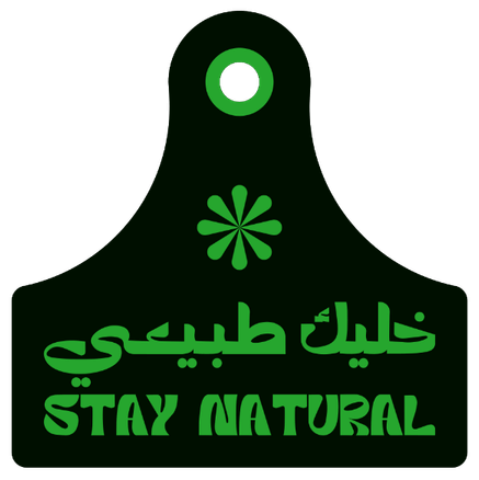 hop owner at Al Aseel Meats standing behind a refrigerated counter of fresh beef and lamb cuts.